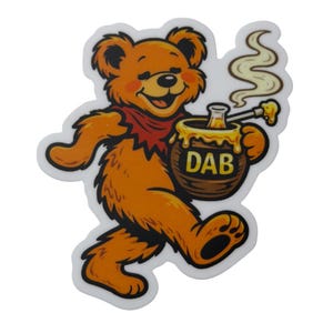 May include: A cartoon-style sticker of a smiling orange bear with a red scarf, holding a honey pot with the word "DAB" on it. The bear is walking and has a white outline.
