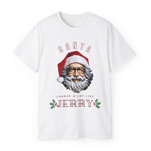 May include: White t-shirt featuring a red and white Santa Claus graphic and the text "SANTA LOOKED A LOT LIKE JERRY" in red.