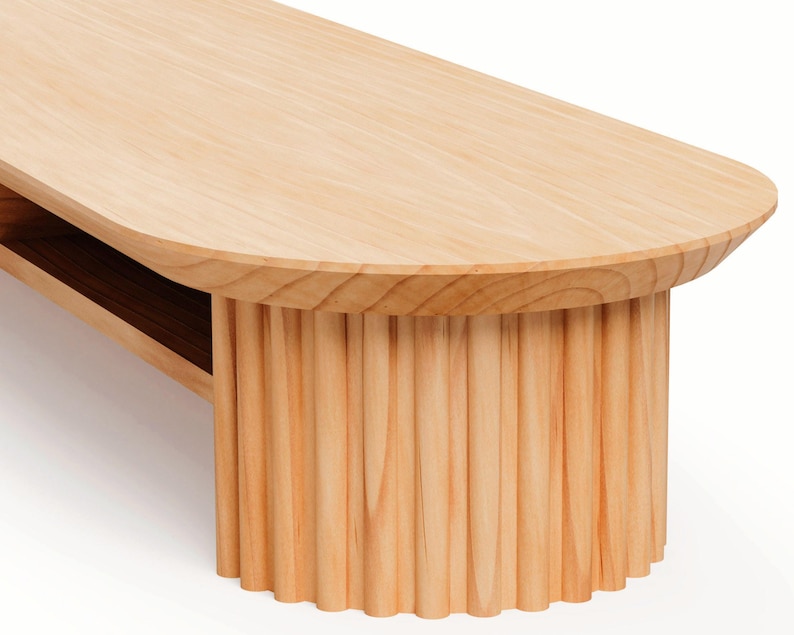 May include: A light-coloured wooden bench with a rounded top and a fluted base. The bench has a natural wood grain finish and a minimalist design. The bench is suitable for a living room or hallway.