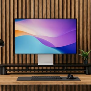 May include: A black desk lamp with a white shade sits on a wooden desk in front of a computer monitor with a colorful abstract background. The monitor is on a black stand with a black keyboard and mouse in front of it.