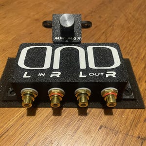 May include: Black audio mixer with gold RCA connectors and a knob labelled "MIN MAX". The mixer has the word "ONO" printed on the front.