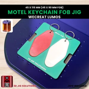 May include: A blue jig with a teal insert holding a red and white motel keychain fob. The text "MOTEL KEYCHAIN FOB JIG" is in green. The dimensions are 45 x 115 mm (45 x 90 mm FOB). The text "WECREAT LUMOS" and "3D JIG SOLUTIONS" are also visible.