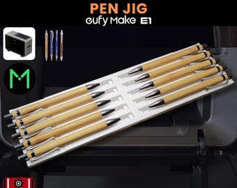 May include: A white pen jig with multiple pens. The pens have a light brown wooden barrel and silver accents. The text on the image reads "9 - 12 MM DIAMETER PEN JIG eufy Make E1" and "3D JIG SOLUTIONS".
