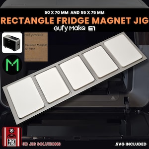 May include: A rectangle fridge magnet jig with the text "50 X 70 MM AND 55 X 75 MM RECTANGLE FRIDGE MAGNET JIG eufy Make E1". The jig holds five white rectangular magnets. A small box of ceramic magnets is also visible.