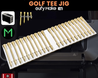 May include: A white golf tee jig with multiple gold-colored golf tees. The text on the image reads "GOLF TEE JIG" and "1-1/2" (40mm) to 3-1/4" (83mm) LENGTH". The product is made by eufy Make E1. The image also includes the text "3D JIG SOLUTIONS" and ".SVG INCLUDED".