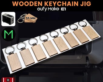 May include: A wooden keychain jig with seven rectangular keychains, each 31 x 55 mm. The keychains are attached to silver keyrings. The text "WOODEN KEYCHAIN JIG" and "cufy Make E1" are displayed. The image also includes the text ".SVG INCLUDED".