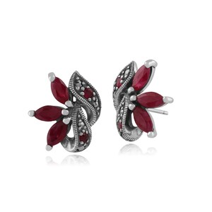 May include: A pair of silver earrings with a floral design. The earrings are adorned with red gemstones and black marcasite.
