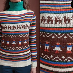 May include: A vintage sweater with a green turtleneck and a cream-colored base. The sweater features horizontal stripes in various colors and detailed patterns of llamas and figures in traditional clothing. The overall design is a blend of retro and folk styles.