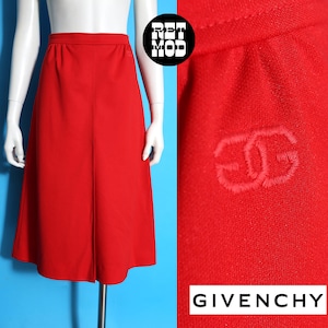May include: A vibrant red skirt with a classic A-line silhouette. The skirt features a high waist and a subtle seam down the front. The Givenchy logo is embroidered on the fabric. The skirt is displayed on a mannequin.