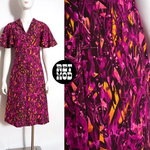 May include: A vintage 1960s dress with a pink and yellow abstract print. The dress has a collared neckline, short sleeves, and a knee-length skirt.