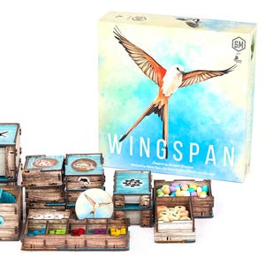 May include: A board game titled "Wingspan" with various wooden game pieces. The game box features a bird with outstretched wings. The game pieces include wooden boxes, trays, and tokens in various colors. The overall aesthetic is natural and inviting.