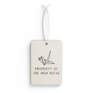 May include: White car air freshener with a black origami crane and the text "PROPERTY OF THE HIGH REEVE".