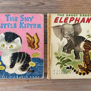 Pode incluir: Dois livros infantis vintage. O primeiro, "The Shy Little Kitten", tem uma capa rosa com uma ilustração de gatinho e borboleta. O segundo, "The Saggy Baggy Elephant", apresenta uma ilustração de elefante e tigre numa capa creme.