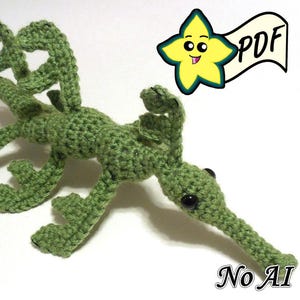 May include: A green crocheted leafy seadragon amigurumi with a long snout and black bead eyes. The figure features intricate, branch-like appendages along its body. A yellow star-shaped icon with the text PDF and the text No AI are visible.