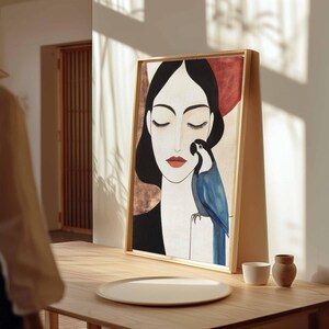 Stylish modern illustration of a serene woman with eyes closed, softly arched brows, and muted red lips. Her dark hair cascades smoothly along her shoulders. A luminous blue parrot with crisp black and white facial markings sits beside her, adding a striking color contrast against the gentle cream and earthy-toned background of this poetic, balanced composition.