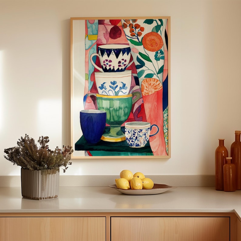 Colorful teacups still life painting showing stacked ceramic cups with floral and geometric designs. Painted in expressive watercolor style, the cups appear against a richly patterned background with botanical elements and fabric-like textures. The artwork conveys warmth, creativity, and a sense of calm inspired by tea rituals and cozy kitchen spaces.