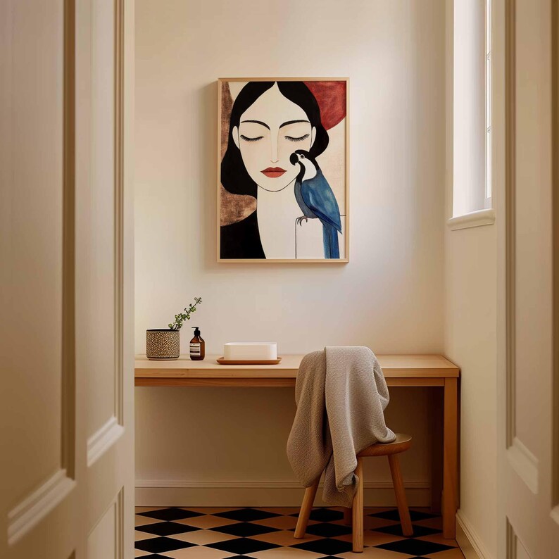 Contemporary minimalist portrait of a woman with smooth pale skin, closed eyes, and flowing black hair, rendered in clean, soft-edged shapes. A richly detailed blue parrot perches at her side, its feathers shaded in deep and light blues. The softly textured background in warm neutral tones supports the tranquil, contemplative atmosphere of the artwork.