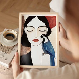 Contemporary feminine illustration featuring a calm woman in profile with eyes closed, smooth ivory-toned skin, and sleek black hair framing her face. A striking blue parrot sits delicately beside her, its detailed feathers rendered in layered shades of blue. The background carries soft earthy tones of beige and muted terracotta, enhancing the quiet emotional connection between the woman and the bird.