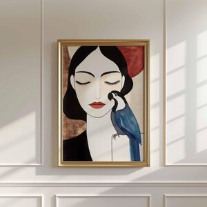 Minimalist feminine portrait with a front-facing woman in stillness, eyes closed, pale ivory skin, and sleek black hair framing her face. A bold blue parrot with sculpted feather details sits close to her cheek, its luminous color standing out against the soft neutral background in cream and earthy red-brown tones.