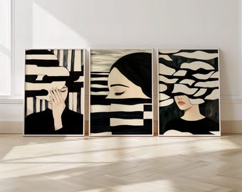 May include: Set of three framed art prints. Each print features a woman's face with black and white abstract designs. The artwork has a minimalist style with a focus on lines and shapes. The color palette is primarily black, white, and beige.