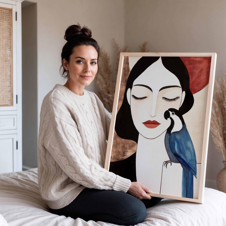 Elegant contemporary artwork featuring a woman in a calm, meditative pose with closed eyes and smooth pale skin. Her long black hair frames her face in clean lines. A vibrant blue parrot perches near her shoulder, its layered feathers creating depth and texture. The warm neutral background of beige and soft terracotta enhances the quiet, intimate mood of the scene.