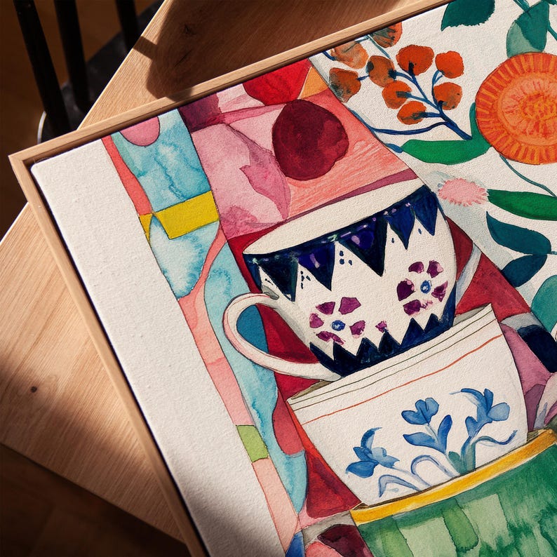Abstract kitchen still life featuring stacked teacups with hand-painted floral designs. The watercolor technique emphasizes texture and softness, while the colorful background and botanical accents create a warm, inviting scene inspired by daily kitchen rituals.