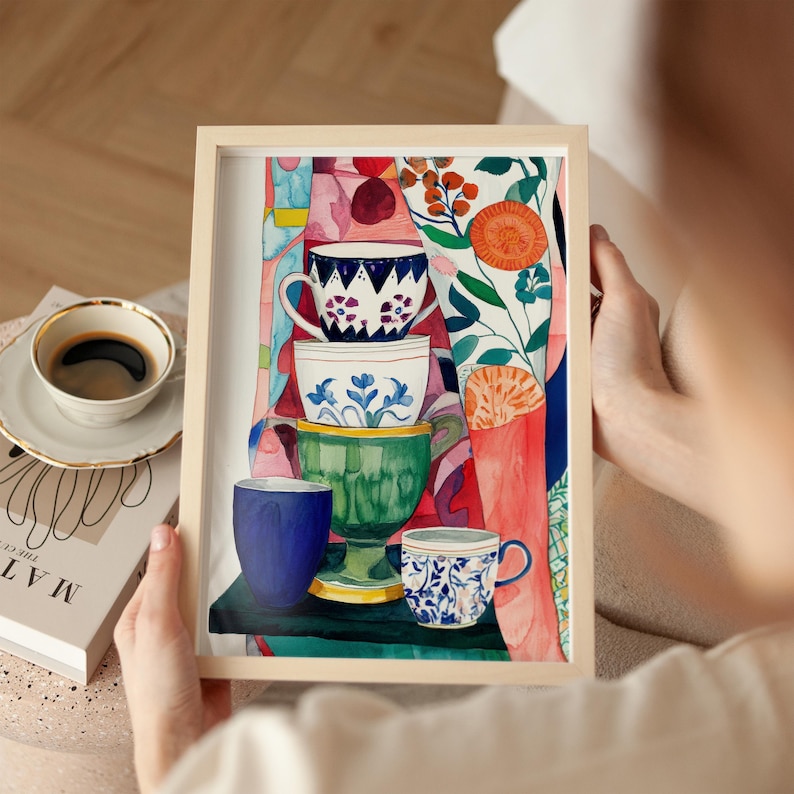 Colorful still life artwork featuring stacked teacups painted in a loose watercolor style. Several ceramic cups are arranged vertically, each with distinct floral and geometric patterns in blue, green, white, and warm tones. Surrounding the cups are abstract botanical elements and patterned backgrounds, creating a cozy kitchen-inspired composition that celebrates tea rituals, handmade objects, and everyday moments.