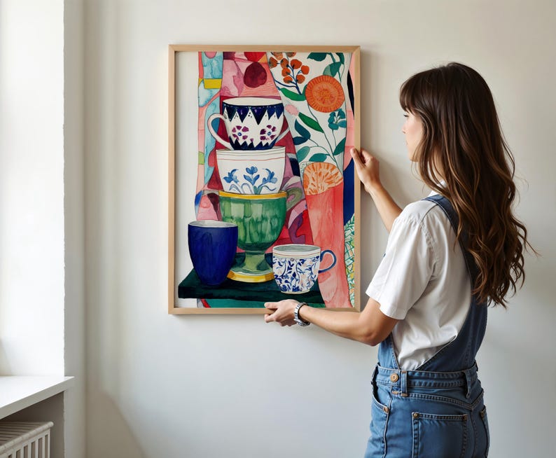 Kitchen-inspired still life artwork showing stacked ceramic teacups painted in watercolor. Floral motifs, textured brushstrokes, and a colorful background create a lively composition. Botanical elements and patterned shapes enhance the sense of warmth and domestic comfort associated with tea time and daily routines.