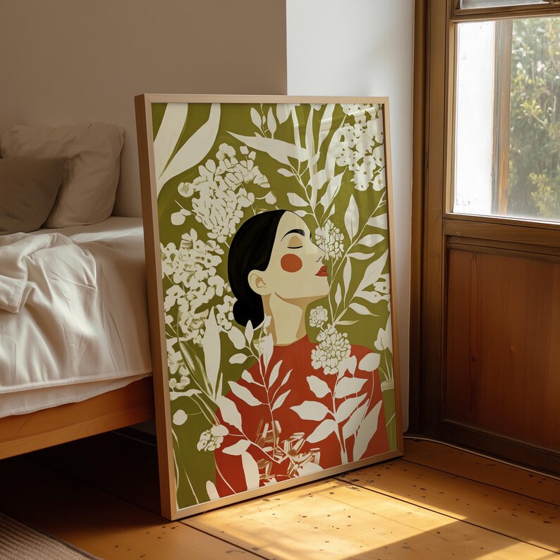 Graphic botanical artwork with a calm female profile at the centre. Cream leaves and clustered flowers form a bold pattern over an olive green background, balanced by the woman’s warm red-orange top.