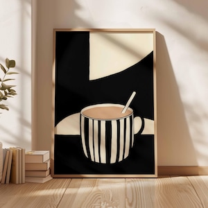 Puede incluir: Impresión artística enmarcada que presenta una taza a rayas blancas y negras llena de un líquido marrón claro y una cuchara. El fondo es una mezcla de formas geométricas negras y crema. La obra de arte está en un marco de madera.