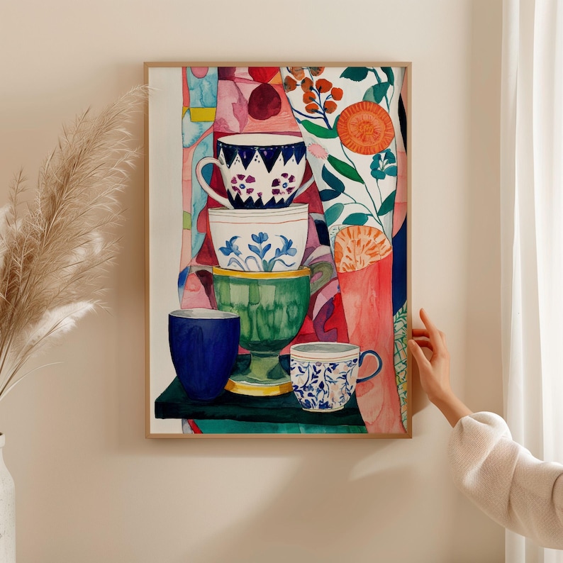 Expressive watercolor still life of stacked ceramic teacups with floral and geometric patterns. The cups are painted in blue, green, and white tones, surrounded by abstract botanical shapes and warm colors. The composition evokes comfort, creativity, and the joy of everyday tea moments.