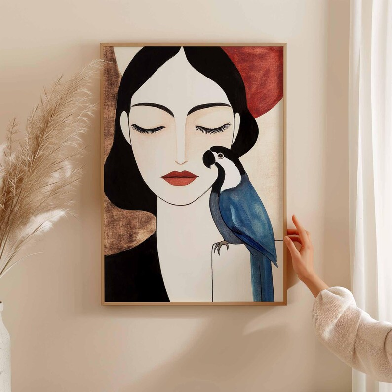 Abstract-modern depiction of a calm woman with long dark hair, closed eyes, and soft red lips set in a balanced symmetrical composition. A striking blue parrot sits closely with curved beak near her face, symbolizing silent connection. The background uses layered neutrals in beige and warm rust tones, creating contrast with the bird’s saturated blue plumage.