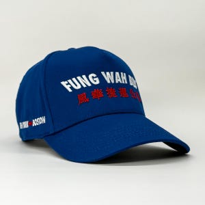 May include: A blue baseball cap featuring the text "FUNG WAH BUS" in white and red. The cap also has text on the side that reads "NEW YORK BOSTON". The hat is made of a durable fabric and has a curved peak.