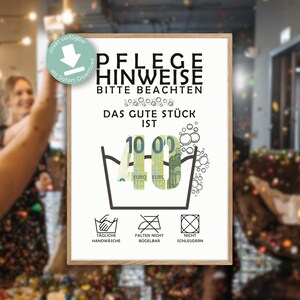 May include: A framed print with German text, featuring a humorous design with a washing tub, bubbles, and Euro banknotes forming the number 40. Includes care instructions symbols for hand washing, no ironing, and no spinning.