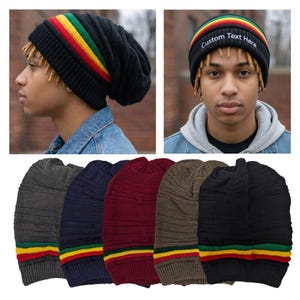 May include: A collection of knit beanies in various colors, including black, gray, navy, burgundy, and brown. Each beanie features a striped band with red, yellow, and green colors. One beanie has the text "Custom Text Here" on the band.