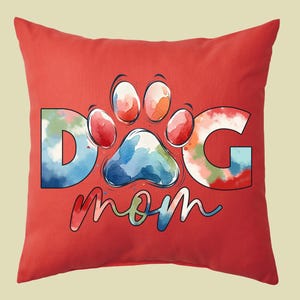 May include: Red throw pillow with a watercolor design of a paw print and the words "Dog Mom".