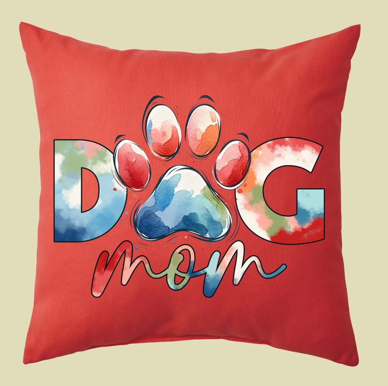 May include: Red throw pillow with a watercolor design of a paw print and the words "Dog Mom".