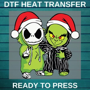 May include: DTF heat transfer featuring two cartoon characters wearing Santa hats. One character is Jack Skellington, the other is the Grinch. The text "READY TO PRESS" is at the bottom. The characters are green, black, white, and red.
