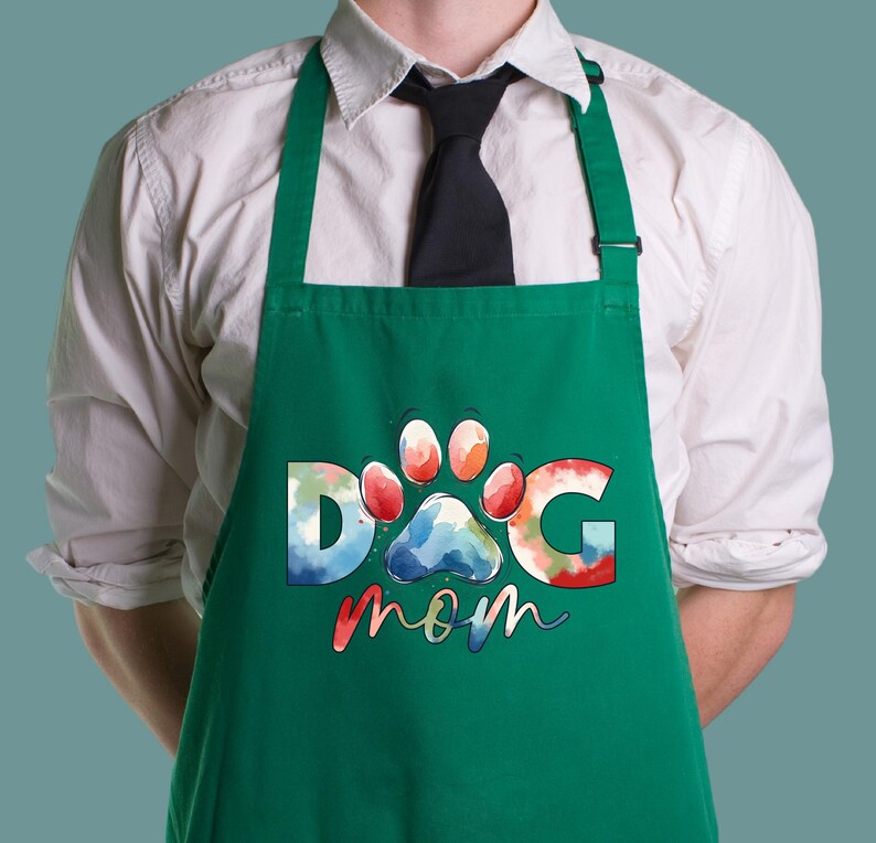 May include: Green apron with a watercolor design of a paw print and the text "Dog Mom".