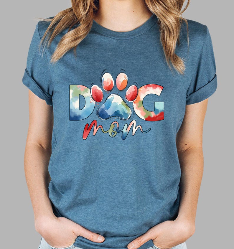 May include: A blue t-shirt with a watercolor design of a paw print and the words "DOG mom".