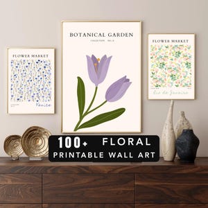 May include: A collection of framed floral art prints. The prints feature botanical illustrations of flowers and text that reads "Botanical Garden" and "Flower Market". The prints are displayed on a dark wood surface with decorative items.