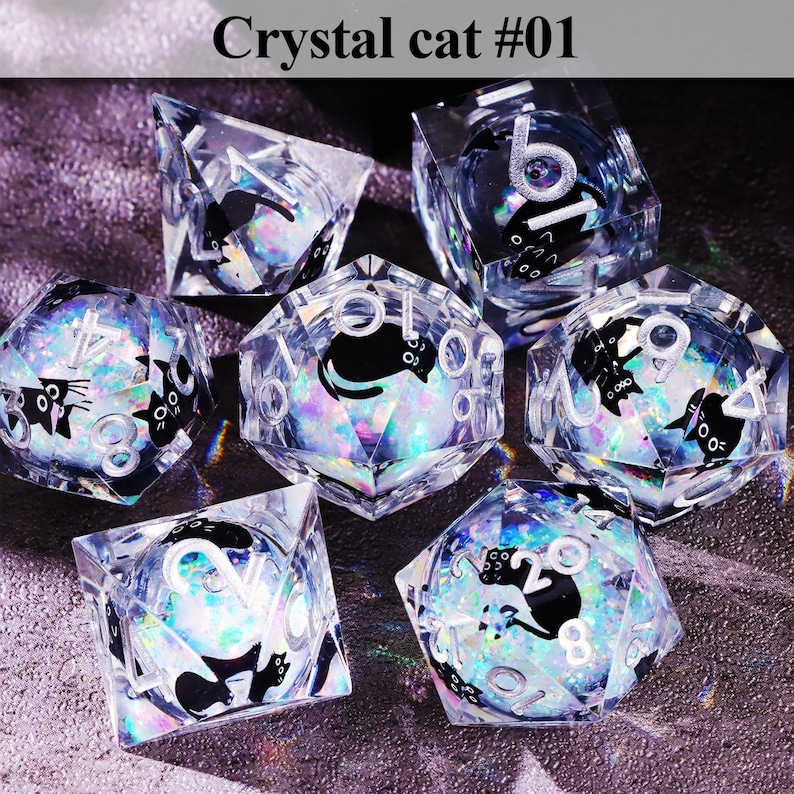 May include: A collection of clear, faceted dice with a black cat silhouette design and white numbers. The dice are iridescent, reflecting multiple colors. The text "Crystal cat #01" is at the top of the image.