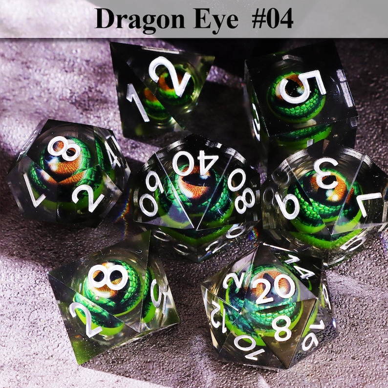 May include: Set of seven polyhedral dice with a dragon eye design. Each die is clear with a green and orange dragon eye core and white numbering. The text "Dragon Eye #04" is at the top.