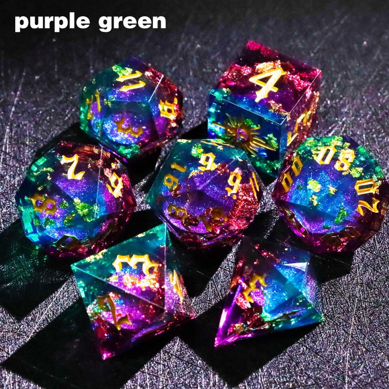May include: Set of seven polyhedral dice in vibrant purple, green, and blue hues. Each die features gold-colored numbers. The dice are made of a translucent material, with a glittery, galaxy-like effect. The text "purple green" is in the top left corner.
