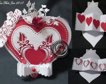 May include: A red and white heart-shaped card with a white lace border and a white heart with a red heart inside. The card has a white bow with a red button in the center. The card is decorated with white flowers and leaves. The card says "With all my love" on the front.