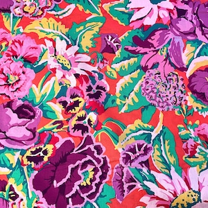 May include: A vibrant floral pattern featuring large blooms in shades of pink, purple, and white against a bright red background. Green and yellow foliage accents the flowers, creating a colorful and eye-catching design.