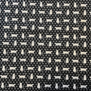 May include: A black fabric featuring a repeating pattern of small, white, stylized cat silhouettes alternating with rows of light gray polka dots. The cats are depicted in various poses, including walking and sitting, arranged in a grid-like layout.