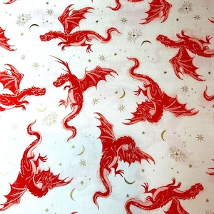 May include: White fabric with a repeating pattern of red dragons, gold stars, crescents, and bursts. The dragons are depicted with outstretched wings and serpentine bodies. The overall design has a fantasy theme.