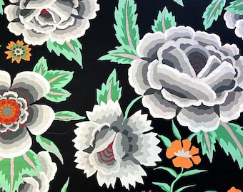 May include: A black floral fabric featuring large, stylized flowers in shades of gray and white, with orange and red centers. Green leaves and smaller orange flowers accent the design. The pattern is repeated across the fabric.