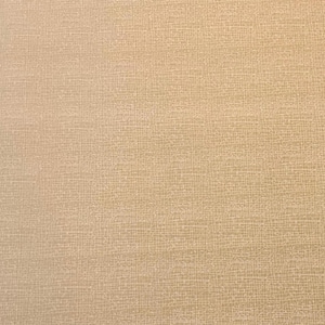 May include: Close-up of a textured, beige fabric. The surface has a subtle, woven pattern, creating a neutral backdrop. The color is a warm, light tan, suitable for various craft projects or home decor.